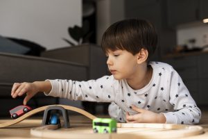 Child playing with wooden car