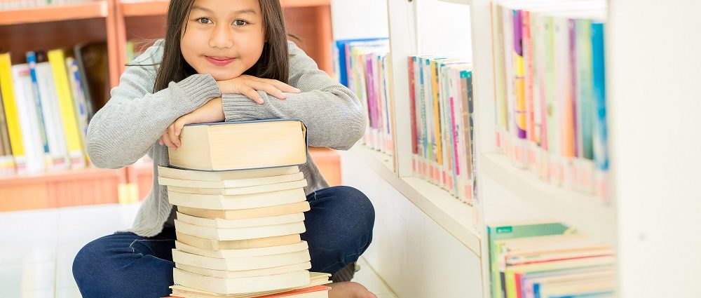 Cute girls and many books in the library