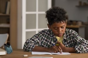 A kid doing homework, struggling