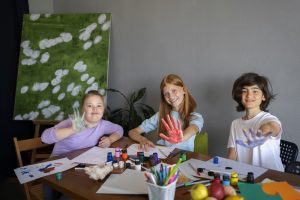 Kids smiling, doing art