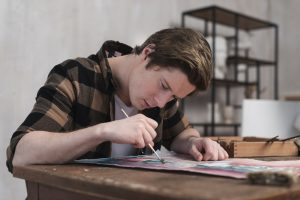 A student painting on a paper