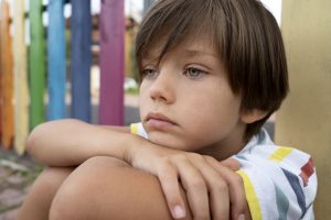 A boy sad in a park