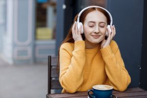 A woman with headphone, smiling
