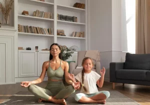 A woman and her daughter meditating