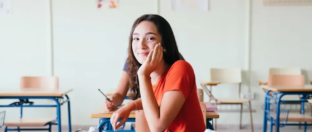 A student posing in the classroom, smiling