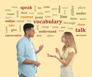 A man and a woman talking with background full of words