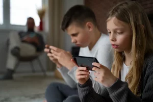 A boy and a girl using their phone