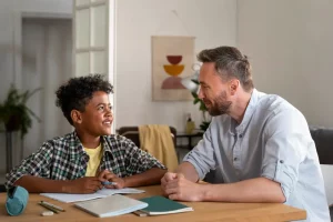 A father and child talking and smiling